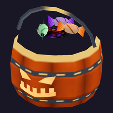 The candy pail pickup: an orange pumpkin bucket with a jack-o'-lantern face, full of wrapped sweets.